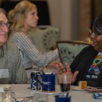 attendees at celebration event chat at their table